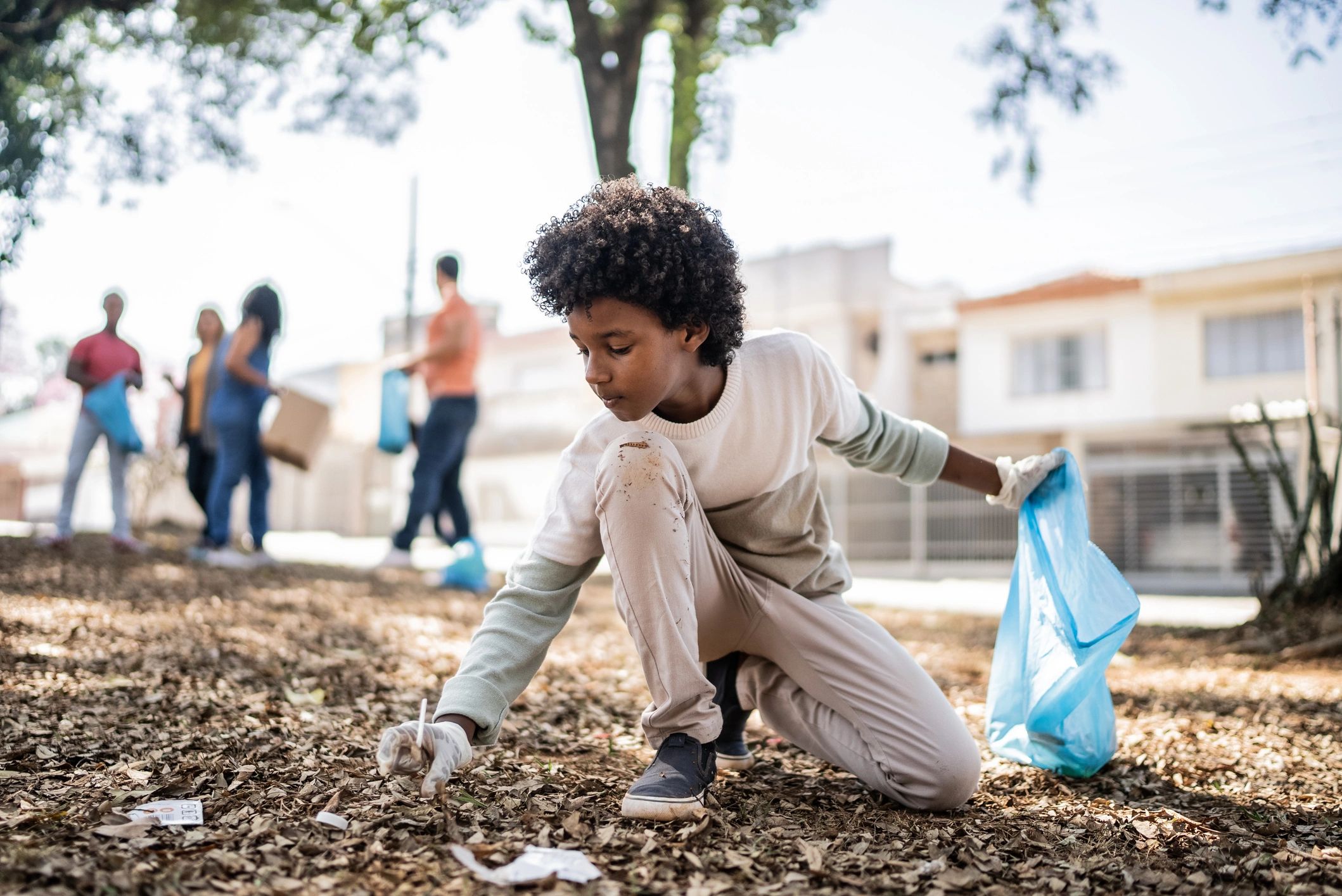 Volunteer picking up litter in a public park