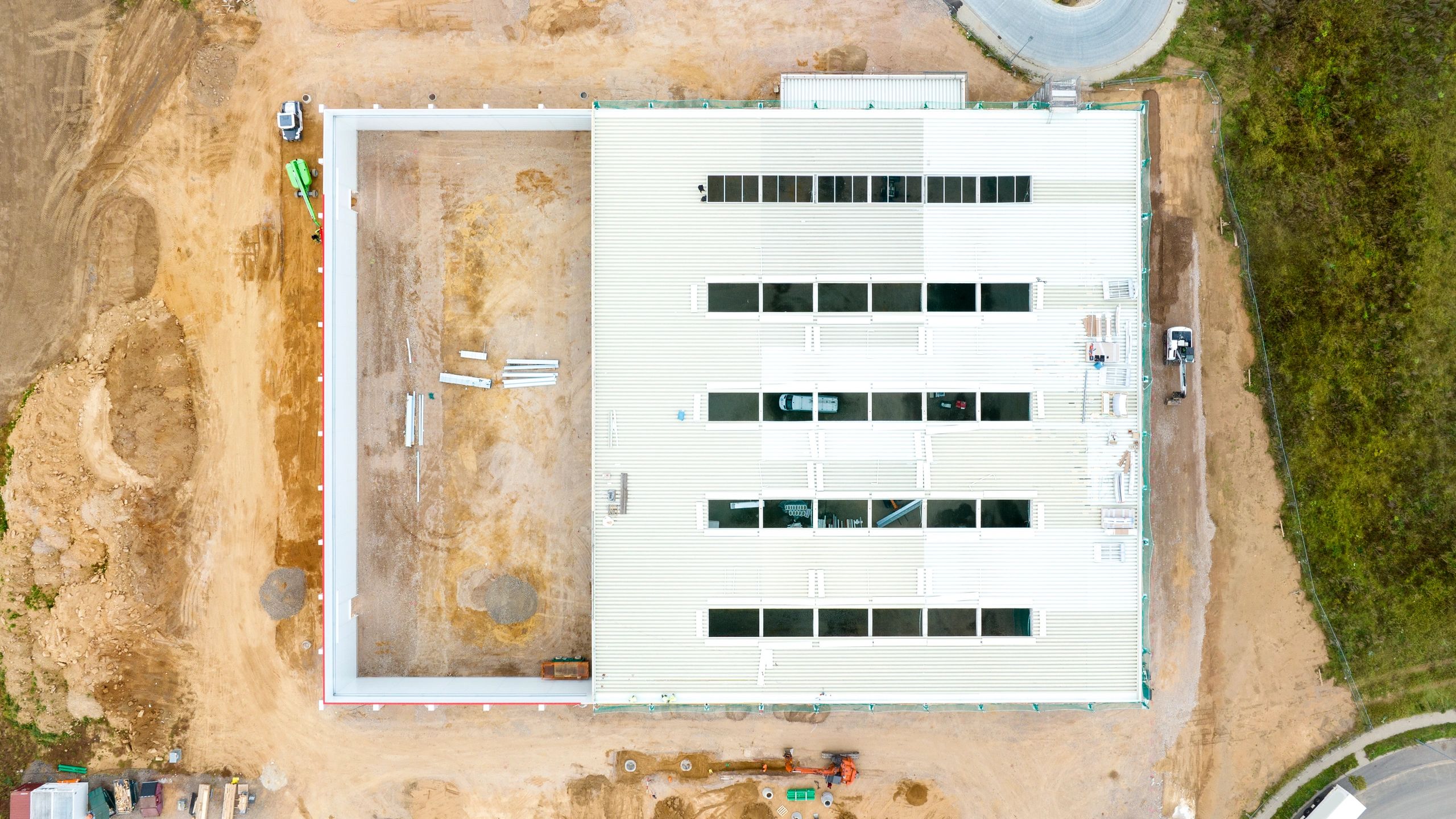 Aerial view of large industrial construction site with multiple buildings under development