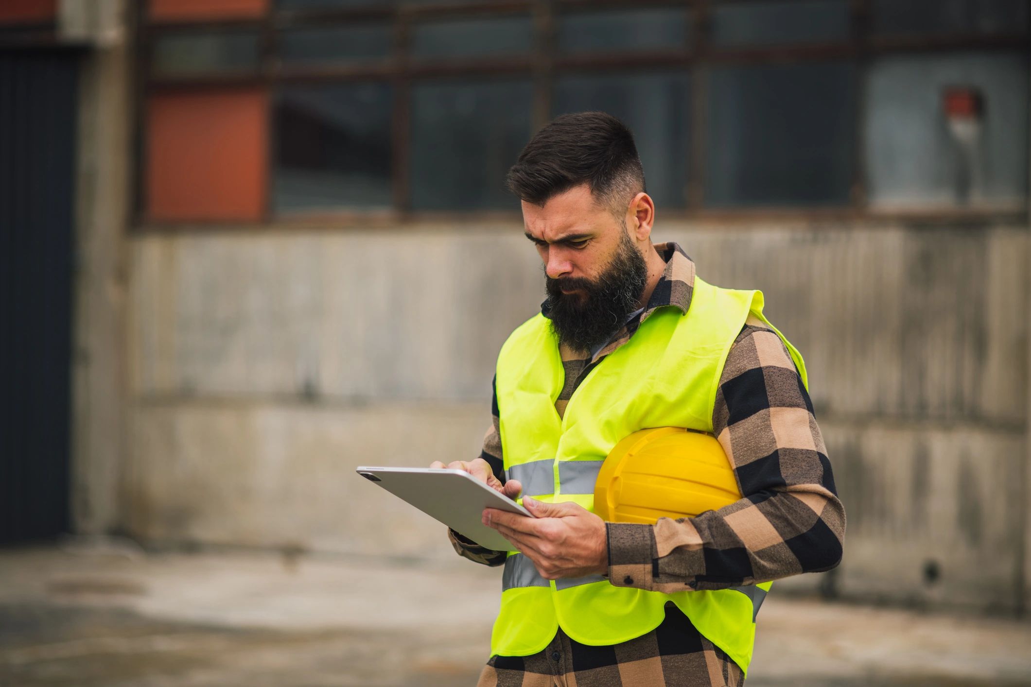 Professional reviewing mapping data on a tablet in the field