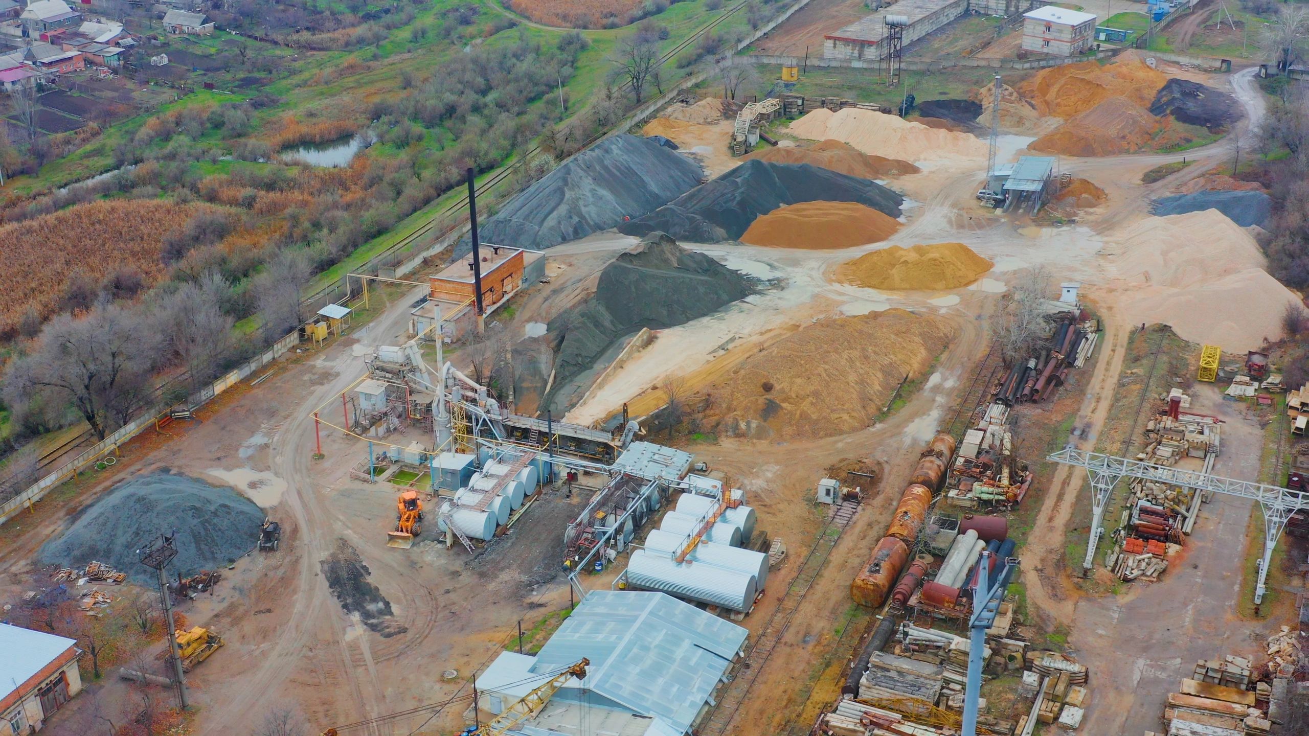 Aerial view of an industrial site with stockpiles and equipment