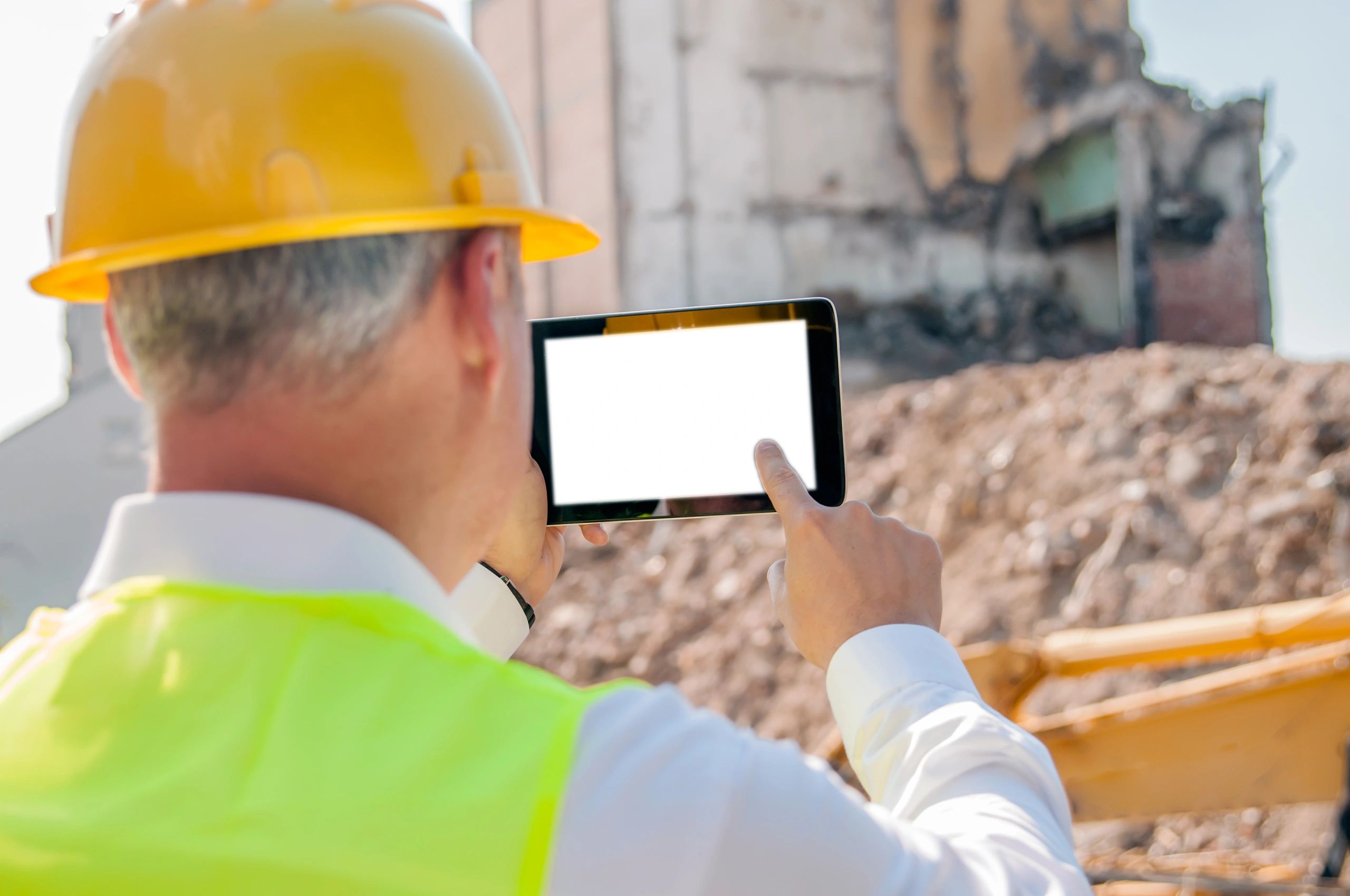 Field professional reviewing site data on a tablet at a construction site